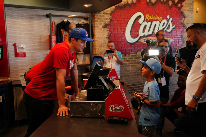 Texas Rangers slugger Corey Seager served diners at an Arlington Raising Cane's an hour after he and teammates celebrated the club's first World Series title with fans at a parade and celebration near Globe Life Field Friday.
